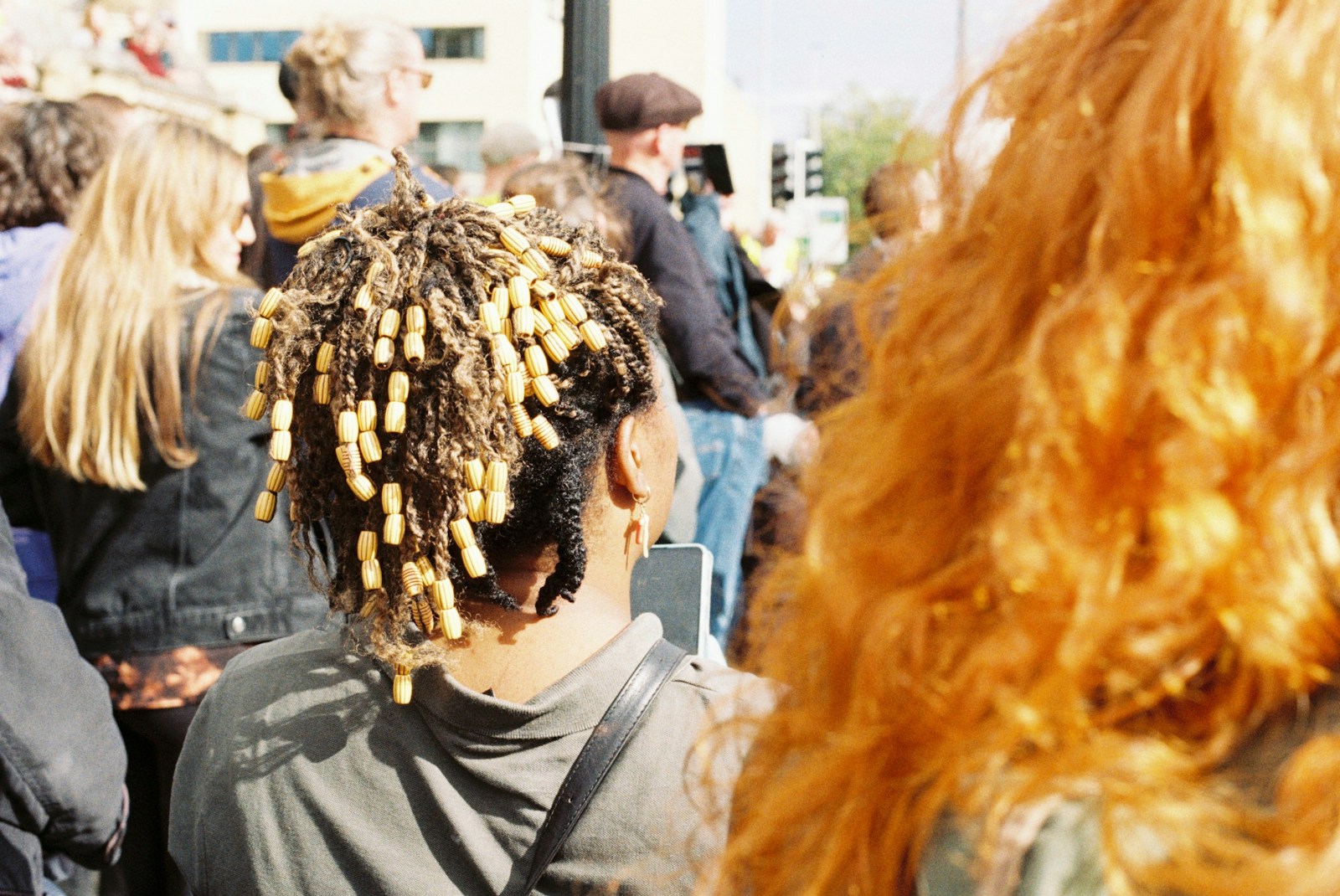 a man with dreadlocks in a crowd of people